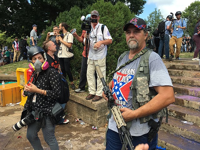 Armed man with confederate flag shirt in Charlottesville
